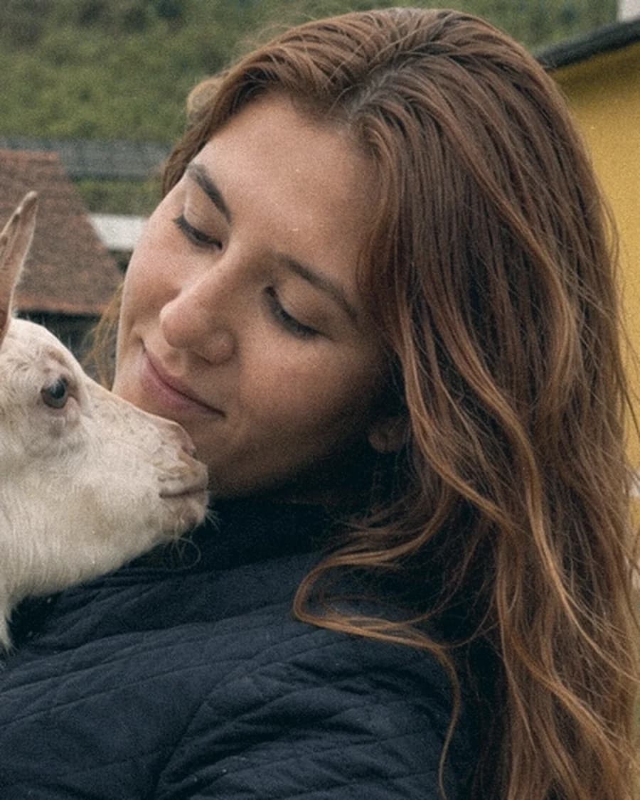 Sophia, cofundadora da Viva Mais Bicho, segurando um filhote no colo